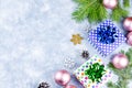 Festive Christmas background with fir branches, Christmas symbols, giftboxes, colorful decorations, copy space. Top view Royalty Free Stock Photo