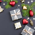 Festive Christmas background with fir branches, giftboxes, red decorations on black, copy space Royalty Free Stock Photo