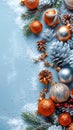 Festive Christmas Background with Ornaments, Pine Cones, and Fir Branches on Snowy Blue Surface Royalty Free Stock Photo