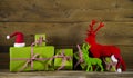 Festive christmas background with presents and reindeer in red a Royalty Free Stock Photo