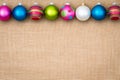 Festive Christmas bauble border on burlap Royalty Free Stock Photo