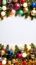 Festive Christmas border with ornaments, lights, pine branches, and copy space on white background Royalty Free Stock Photo