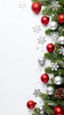 Festive Christmas border with ornaments, pine branches, and snowflakes on white background Royalty Free Stock Photo