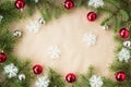 Festive christmas border with red and silver balls on fir branches and snowflakes on rustic beige background Royalty Free Stock Photo