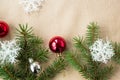 Festive christmas border with red and silver balls on fir branches and snowflakes on rustic beige background Royalty Free Stock Photo