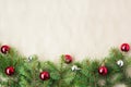 Festive christmas border with red and silver balls on fir branches and snowflakes on rustic beige background Royalty Free Stock Photo