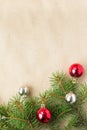 Festive christmas border with red and silver balls on fir branches and snowflakes on rustic beige background Royalty Free Stock Photo