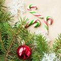 Festive christmas border with red and silver balls on fir branches and snowflakes on rustic beige background Royalty Free Stock Photo