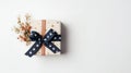 A Festive Christmas Box With A Ribbon In Light Orange And Navy