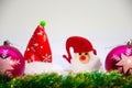 Two pink christmas balls,toy Santa and Christmas decoration on a white background