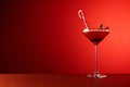 Festive christmas cocktail. Studio shot against a red background