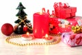 Festive New Year composition with gift boxes, burning candles and New Year`s decor.