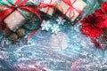 Festive Christmas composition with gifts, boxes, cones, walnuts, red flowers of poinsettia on a wooden background with white sprin Royalty Free Stock Photo
