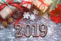 Figures 2019. New year of the pig. Festive Christmas composition with gifts, boxes, cones, walnuts, red flowers poinsettia on a wo Royalty Free Stock Photo