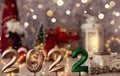 Festive Christmas composition with golden numbers 2022 and sparkles. Santa claus, burning lantern and gifts with Christmas tree on Royalty Free Stock Photo