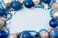 Festive christmas frame with blue and silver balls, sparkling stars and decorative beads with copy space Royalty Free Stock Photo