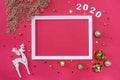 Festive christmas frame made of golden balls, fir tree branches, decorations and confetti on pastel pink background Royalty Free Stock Photo