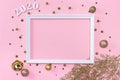 Festive christmas frame made of golden balls, fir tree branches, decorations and confetti on pastel pink background Royalty Free Stock Photo