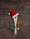 Festive christmas kitchen wooden utensil with cutted reindeer, cinnamon, white snowflake and fir-tree branch