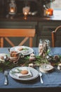 Festive Christmas and New Year table setting in scandinavian style with rustic handmade details in natural and white tones Royalty Free Stock Photo