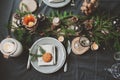 Festive Christmas and New Year table setting in scandinavian style with rustic handmade details in natural and white tones Royalty Free Stock Photo