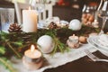 Festive Christmas and New Year table setting in scandinavian style with rustic handmade details in natural and white tones Royalty Free Stock Photo