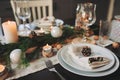 Festive Christmas and New Year table setting in scandinavian style with rustic handmade details in natural and white tones Royalty Free Stock Photo