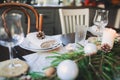 Festive Christmas and New Year table setting in scandinavian style with rustic handmade details in natural and white tones Royalty Free Stock Photo