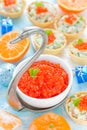 Festive Christmas table with refreshments - red caviar in a bowl Royalty Free Stock Photo