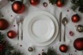 Festive Christmas Table Setting with Empty White Plate and Holiday Decorations Royalty Free Stock Photo