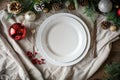 Festive Christmas Table Setting with Empty White Plate and Holiday Decorations Royalty Free Stock Photo