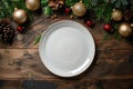 Festive Christmas Table Setting with Empty White Plate and Holiday Decorations Royalty Free Stock Photo