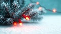 Festive Christmas tree branches adorned with glowing red lights on a soft surface Royalty Free Stock Photo