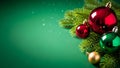 Festive christmas tree branches adorned with shiny baubles on a green background Royalty Free Stock Photo