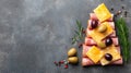 A festive Christmas tree composed of cold cuts, cheese, tomatoes, and olives is arranged on a tray Royalty Free Stock Photo