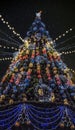 Shining Christmas tree against the background of the night starry sky Royalty Free Stock Photo