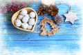 Festive Christmas tree decorations with balls, wooden ornamnets, pine cones on wooden painted background, top view Royalty Free Stock Photo