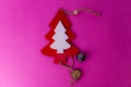 Festive Christmas winter winter happy beautiful pink purple background small toy wooden homemade cute Christmas tree. Flat lay. Royalty Free Stock Photo