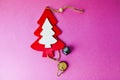 Festive Christmas winter winter happy beautiful pink purple background small toy wooden homemade cute Christmas tree. Flat lay. Royalty Free Stock Photo