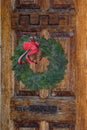 Festive Christmas wreath on door at Christmastime Royalty Free Stock Photo