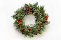 Festive Christmas wreath of fresh natural spruce branches with red holly berries. Traditional decoration for Xmas. Royalty Free Stock Photo