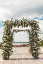 A festive chuppah decorated with fresh beautiful flowers for an outdoor wedding ceremony Royalty Free Stock Photo