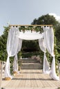 A festive chuppah decorated with fresh beautiful flowers for an outdoor wedding ceremony Royalty Free Stock Photo