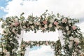 A festive chuppah decorated with fresh beautiful flowers for an outdoor wedding ceremony Royalty Free Stock Photo