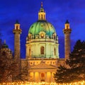 Festive cityscape - view of the Karlskirche St. Charles Church and the Christmas Market on Karlsplatz Charles` Square in the c