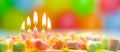 Festive colorful birthday banner with five burning candles on the cake and colorful balloons on background. Space for Royalty Free Stock Photo