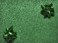 Festive colorful bows on sparkling glitter paper texture. Royalty Free Stock Photo