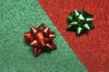 Festive colorful bows on sparkling glitter paper texture. Royalty Free Stock Photo
