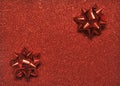 Festive colorful bows on sparkling glitter paper texture. Holiday background. Royalty Free Stock Photo