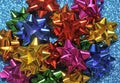 Festive colorful bows on sparkling glitter paper texture. Holiday background. Royalty Free Stock Photo